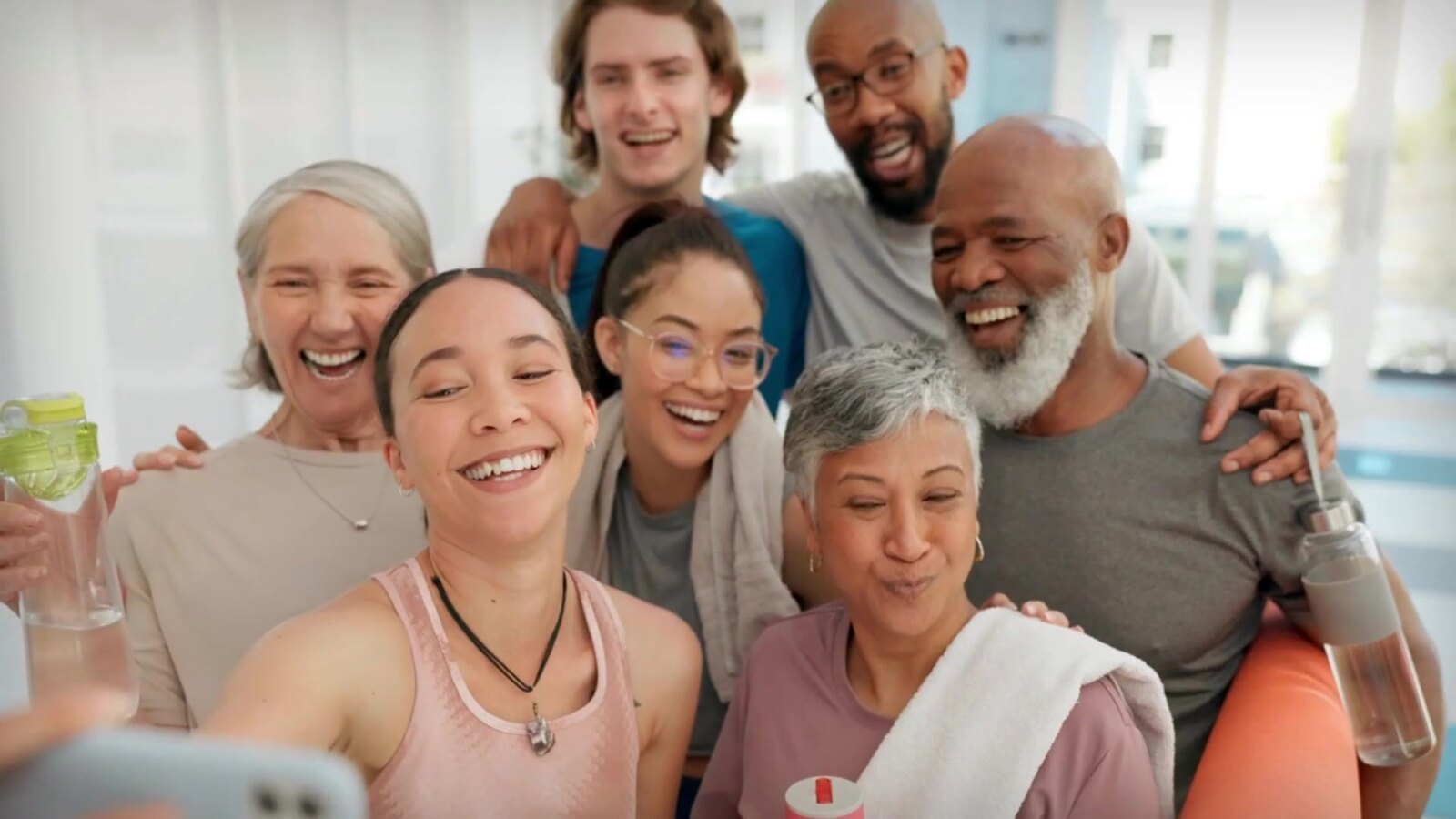 A diverse group of people smiling together